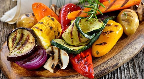 Vegan cuisine: Grilled mixed vegetables on a wooden cutting board